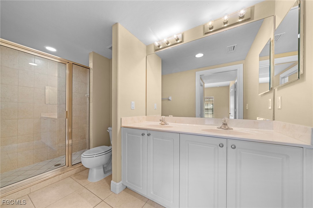 4110 Castilla Circle, Unit 104 Fort Myers, FL 33916 - Photo 12 of 37 a bathroom with a double vanity sink toilet and shower