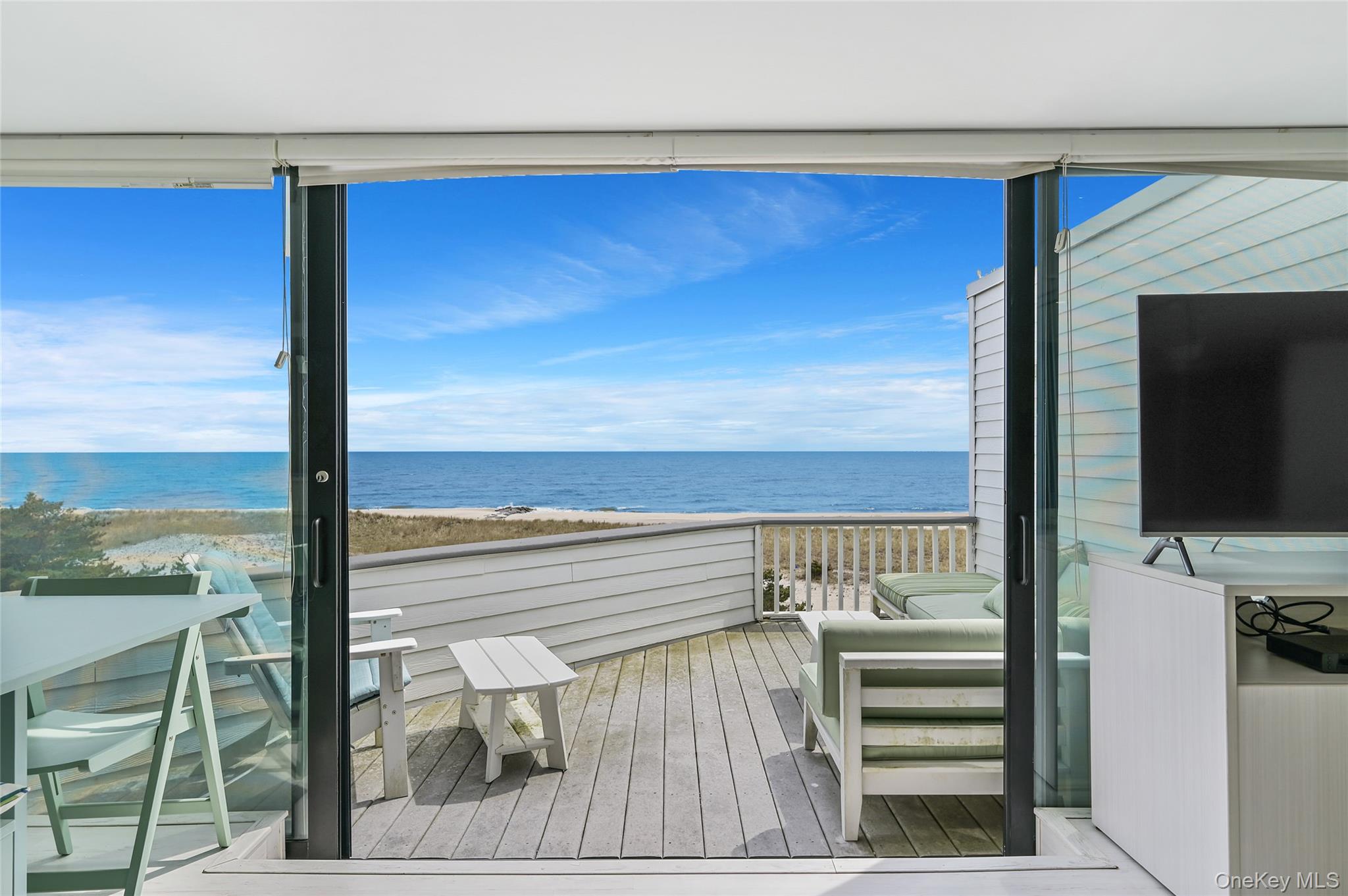 265 Dune Road, Unit 68 Westhampton Beach, NY 11978 - Photo 12 of 25 a view of a balcony with floor to ceiling window and an outdoor view