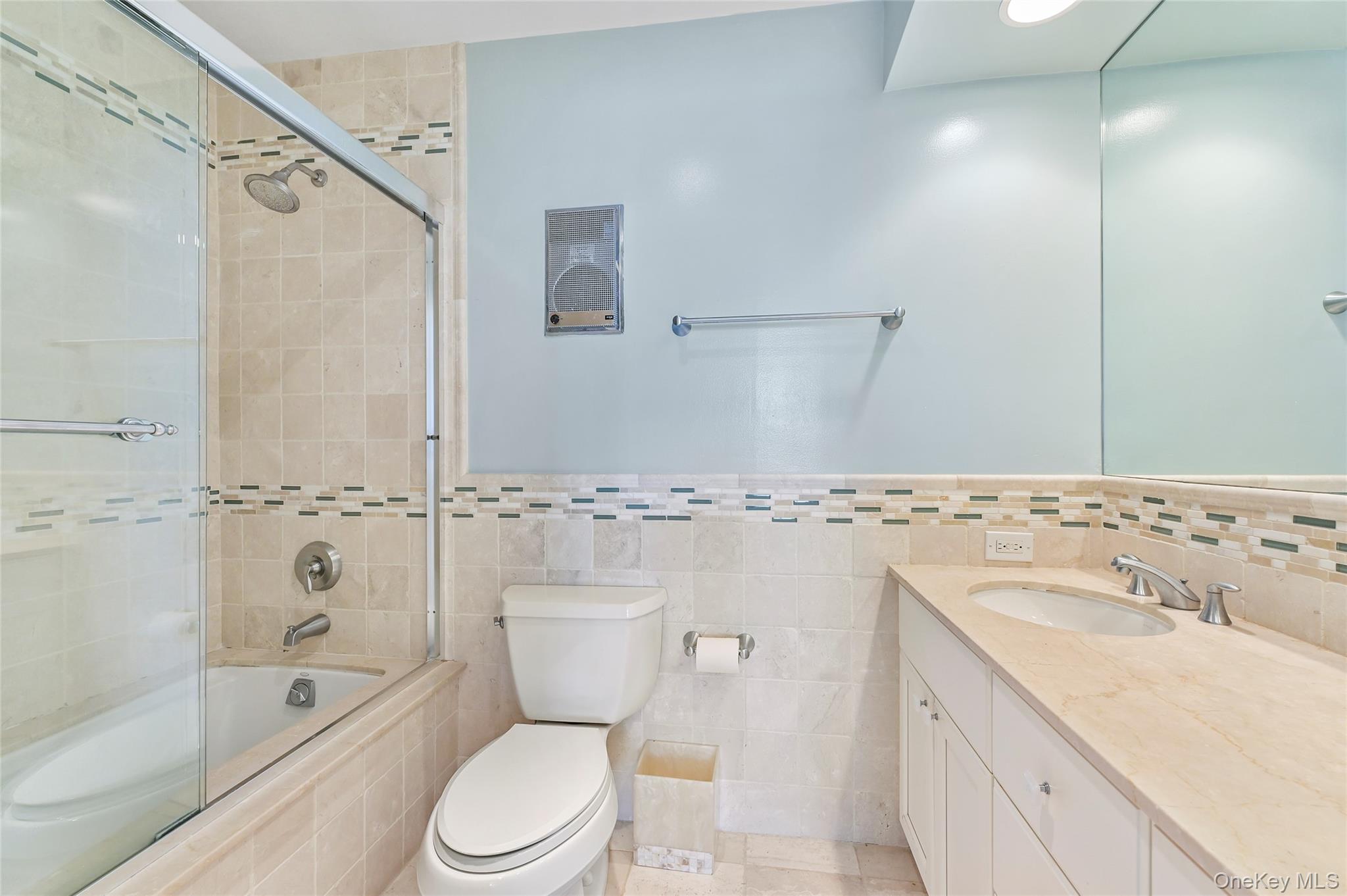 265 Dune Road, Unit 68 Westhampton Beach, NY 11978 - Photo 16 of 25 a bathroom with a sink toilet a shower and bathtub