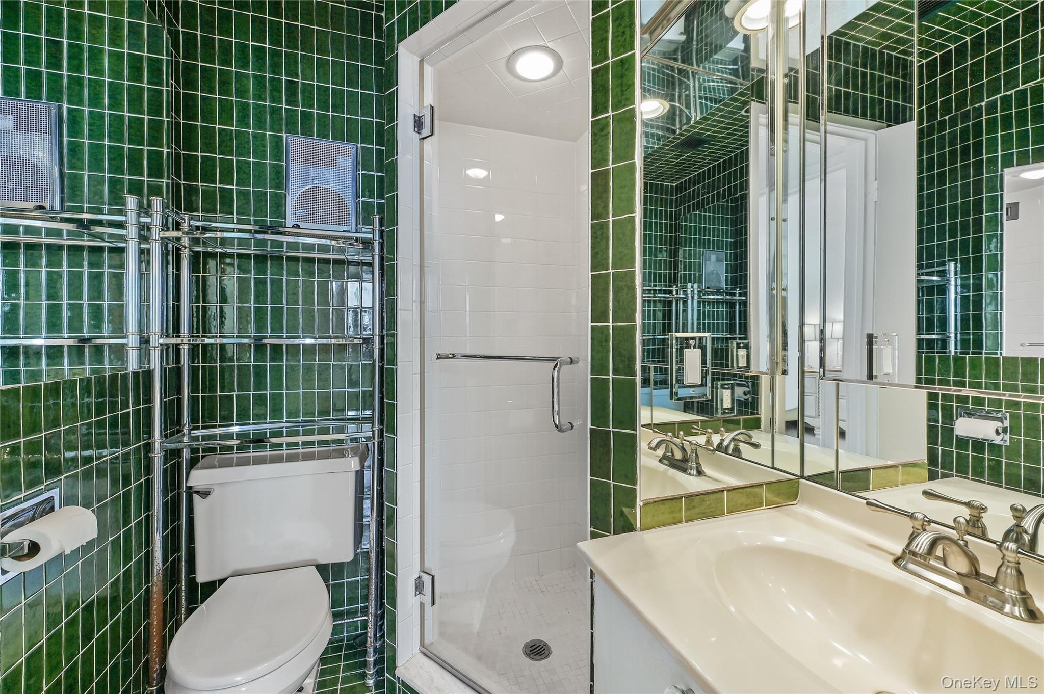265 Dune Road, Unit 68 Westhampton Beach, NY 11978 - Photo 18 of 25 a bathroom with a sink toilet and shower
