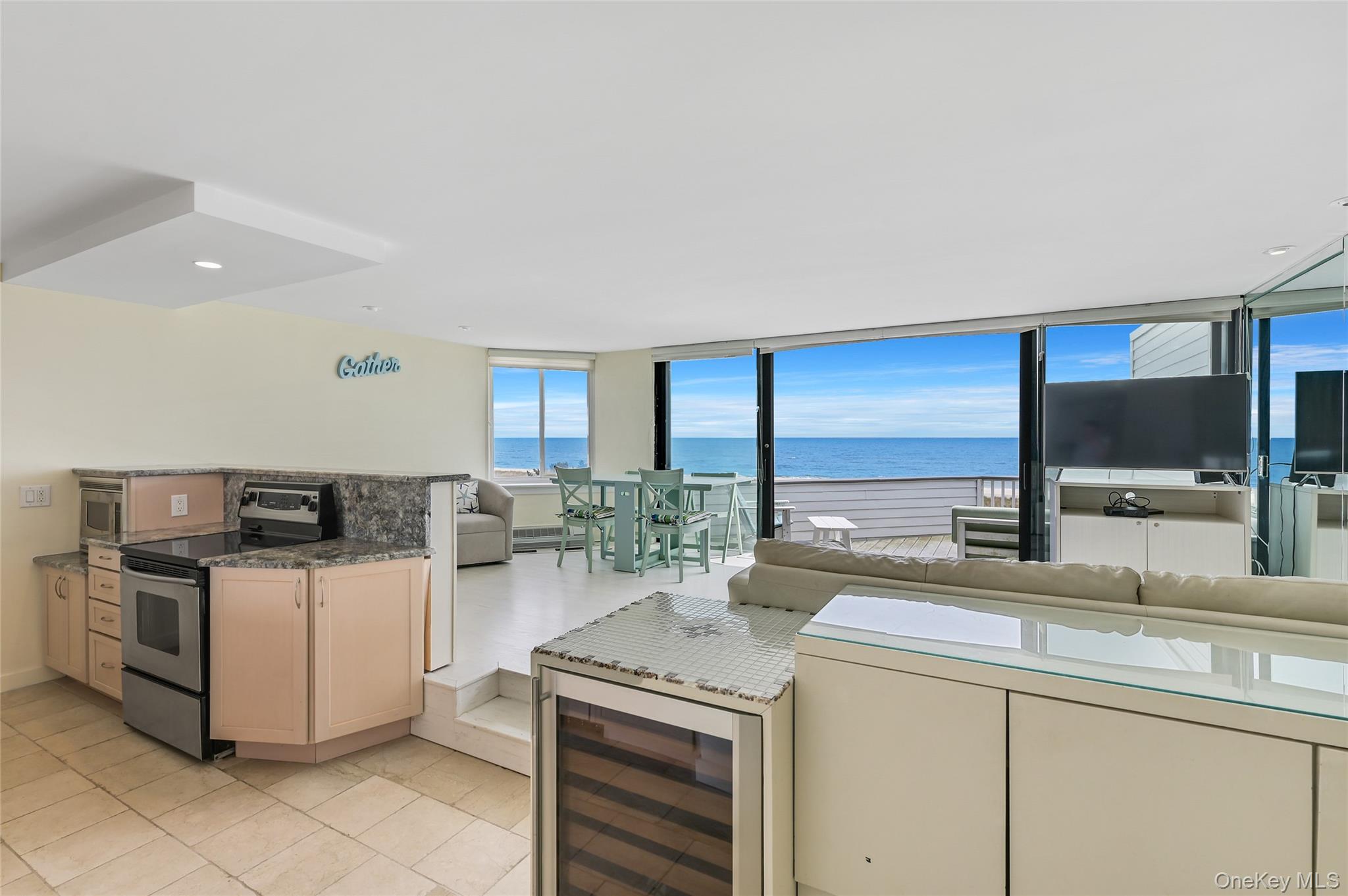 265 Dune Road, Unit 68 Westhampton Beach, NY 11978 - Photo 3 of 25 a kitchen with a stove and a microwave