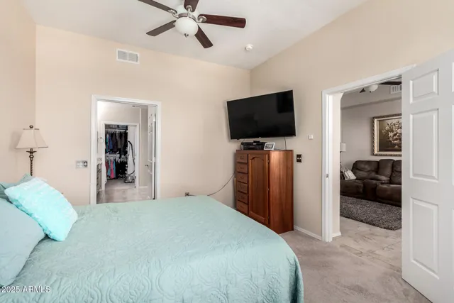 a bedroom with a bed and a flat screen tv
