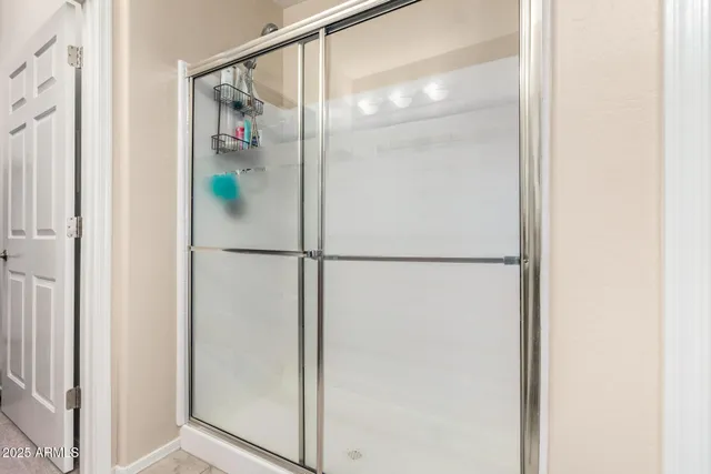 a bathroom with a glass shower door