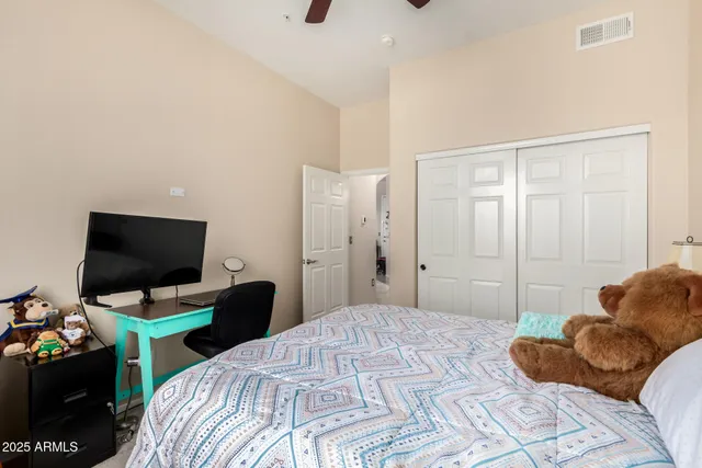 a bedroom with a bed and a flat screen tv