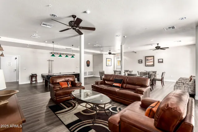 a living room with furniture and a wooden floor