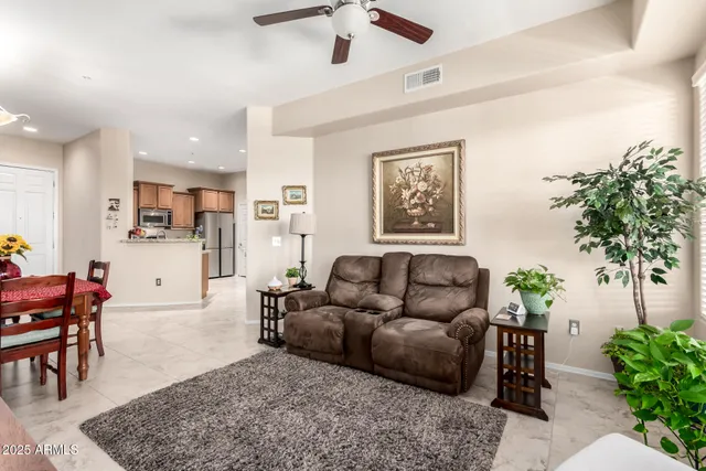 a living room with furniture and a potted plant