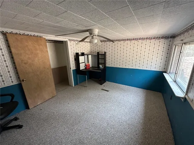 a kitchen with stainless steel appliances kitchen island granite countertop a stove refrigerator and microwave