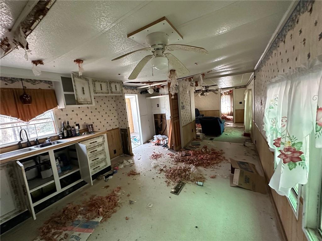 240-246 Harmony Drive Flinton, PA 16640 - Photo 9 of 13 a kitchen with stainless steel appliances kitchen island granite countertop a stove refrigerator and microwave