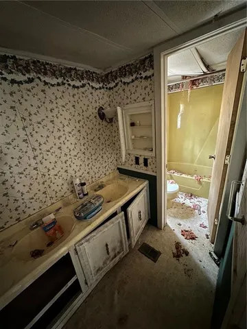 a kitchen with granite countertop a sink a counter top space appliances and cabinets