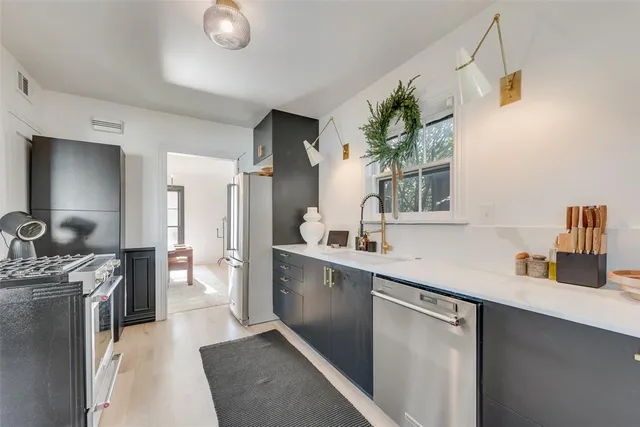 a kitchen with a sink stove and refrigerator