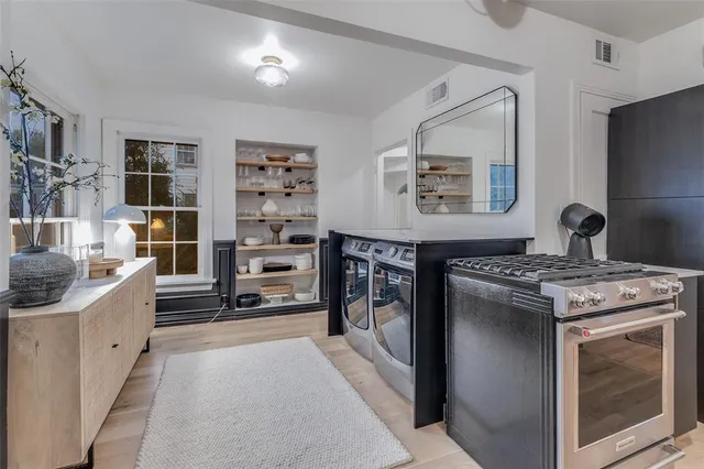 a kitchen with stainless steel appliances granite countertop a stove and a refrigerator