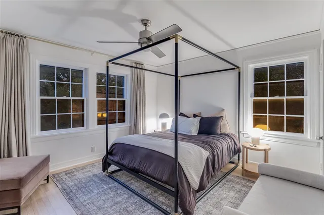 a bedroom with a bed next to a window