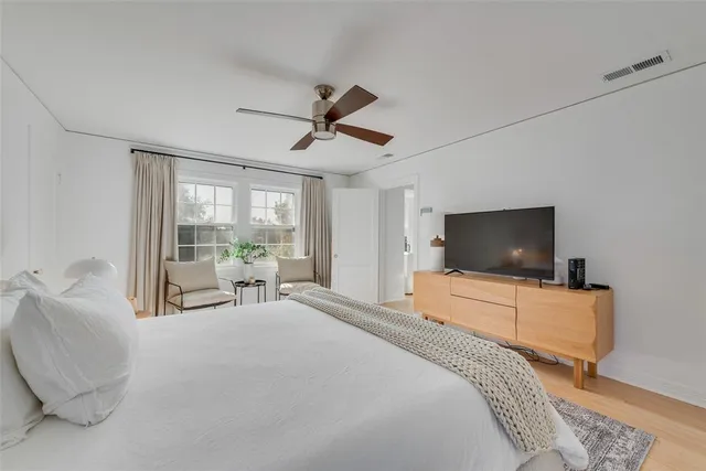 a bedroom with a bed and large window