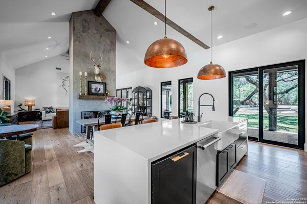 a kitchen with stainless steel appliances granite countertop a stove and a wooden floors