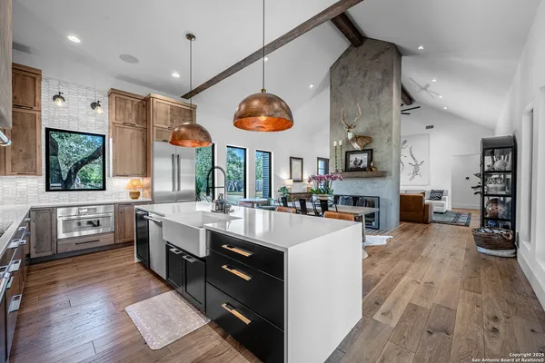 a large kitchen with stainless steel appliances kitchen island granite countertop a large island in the center