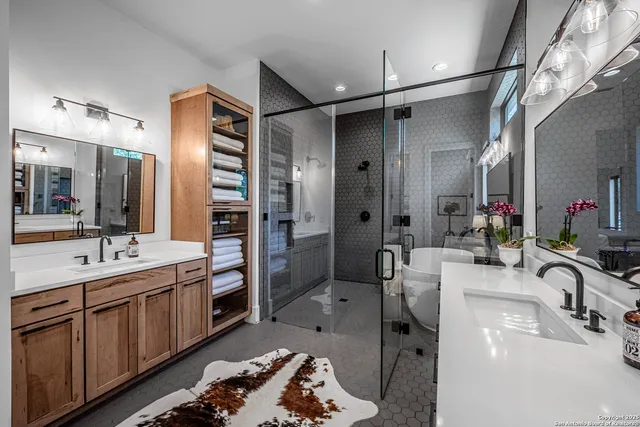 a bathroom with a double vanity sink mirror and shower