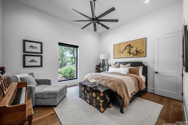 a spacious bedroom with a bed a couch and a window