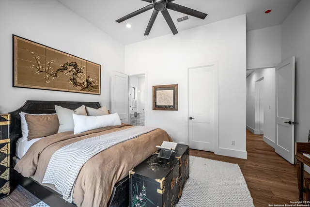 a bedroom with bed and wooden floor