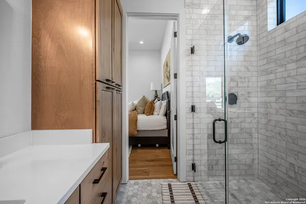 a bathroom with a sink a toilet and shower