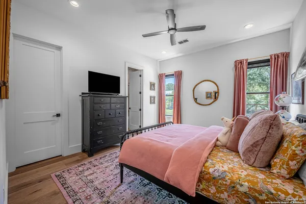 a bedroom with a bed and a television