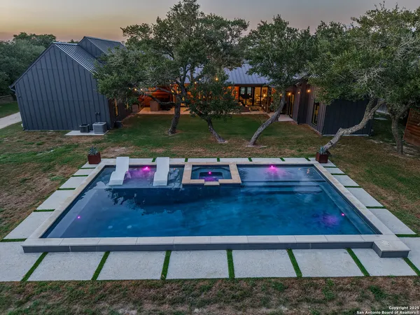 swimming pool view with a seating space