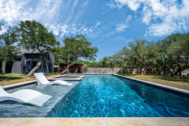 a view of a swimming pool with a lounge chair
