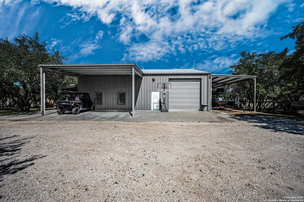 a view of a house with a yard and garage