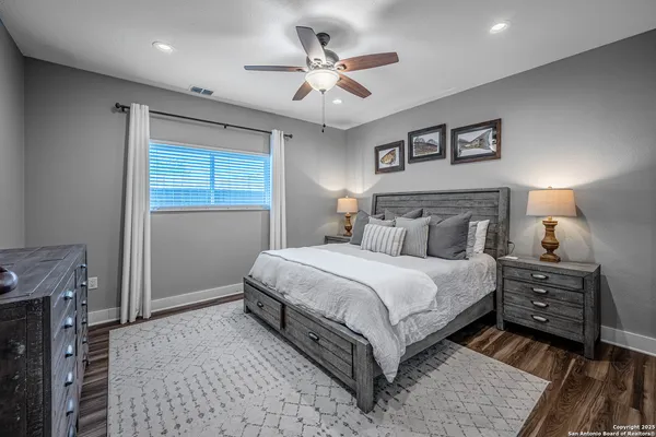 a bedroom with a bed and a ceiling fan
