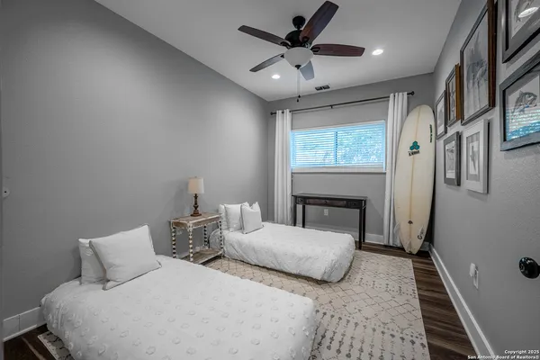 a bedroom with two beds and a chandelier