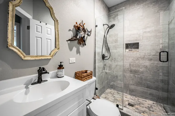 a bathroom with a sink toilet and shower