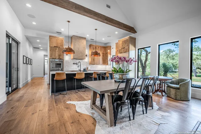 a view of a dining room with furniture and chandelier