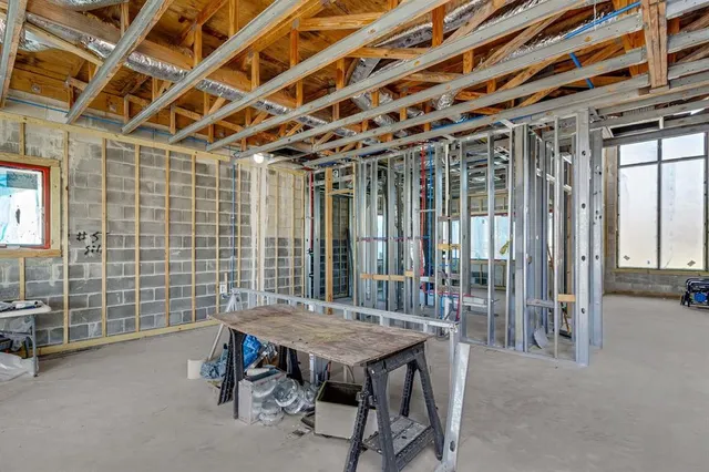 a view of a dining room with furniture wooden floor and windows
