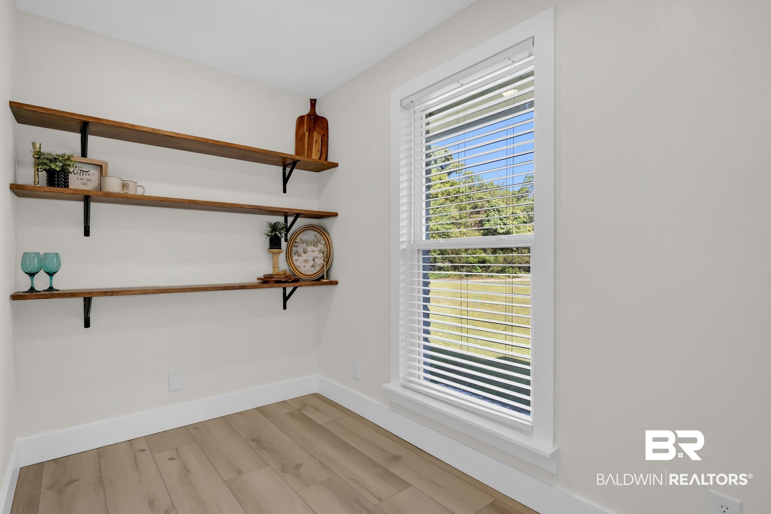 8170 Wilmer Georgetown Road Wilmer, AL 36587 - Photo 10 of 31 Light wood-finish flooring complements the neutral wall color