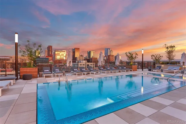 a view of swimming pool outdoor seating and city view