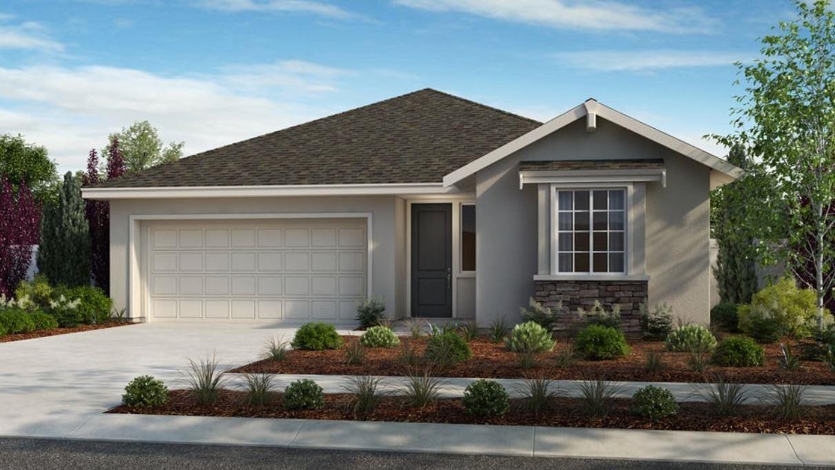 a front view of a house with garage and plants
