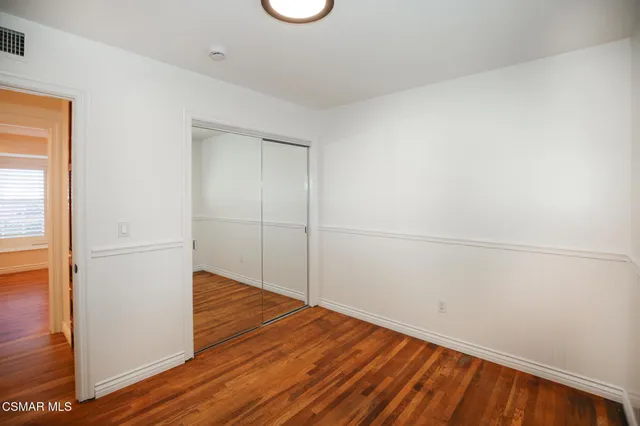 a view of a room with wooden floor