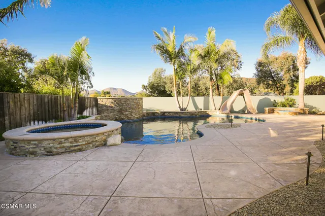a view of a swimming pool with an outdoor seating