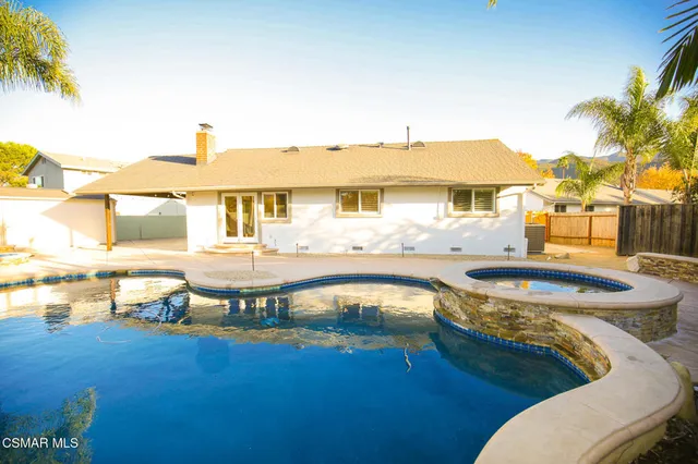 a view of a swimming pool with outdoor seating