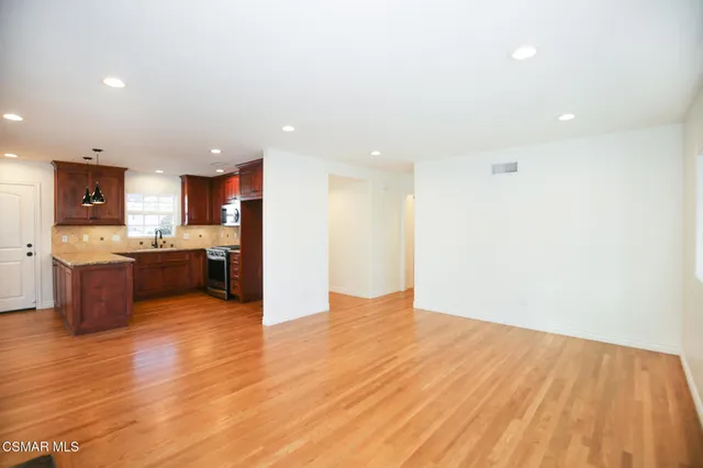 a view of kitchen and kitchen with a sink