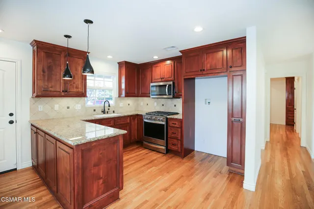 a kitchen with a sink stove and refrigerator