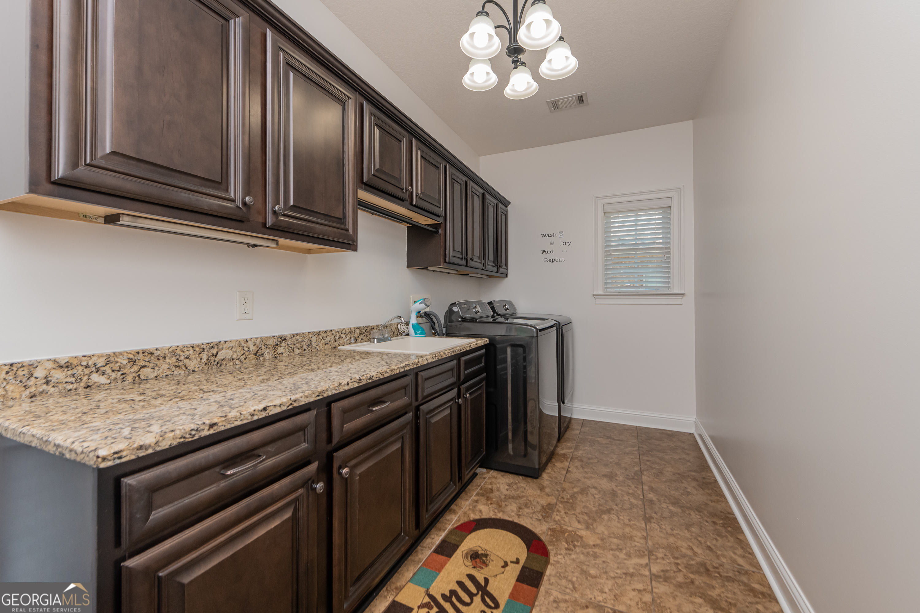 405 Old Bridge Road Warner Robins, GA 31088 - Photo 25 of 55 a kitchen with stainless steel appliances granite countertop a sink stove and cabinets