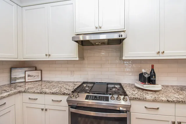 a stove top oven sitting inside of a kitchen