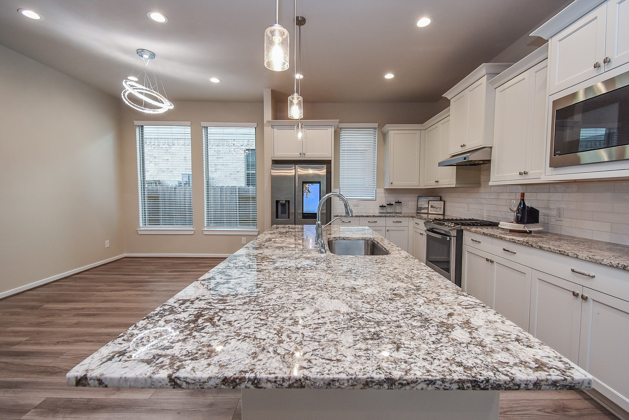 7322 Perching Hawk Trail Katy, TX 77493 - Photo 12 of 38 a kitchen with kitchen island granite countertop wooden cabinets and a sink