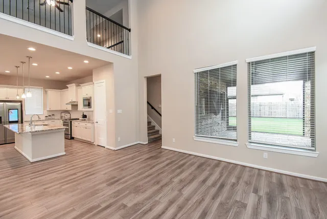 a view of kitchen with wooden floor and electronic appliances