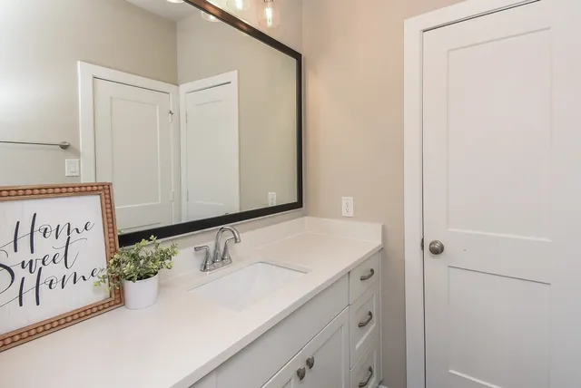 a bathroom with a sink and a mirror