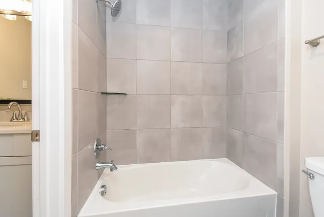 a white bath tub sitting next to a white sink