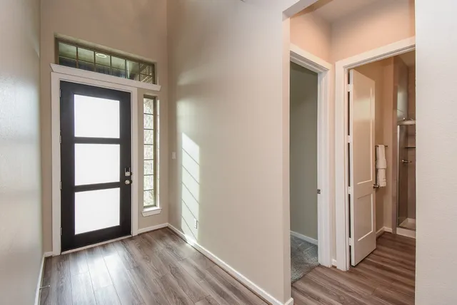 a view of front door with wooden floor