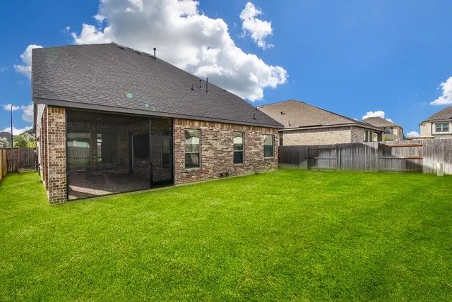 a view of a house with a backyard