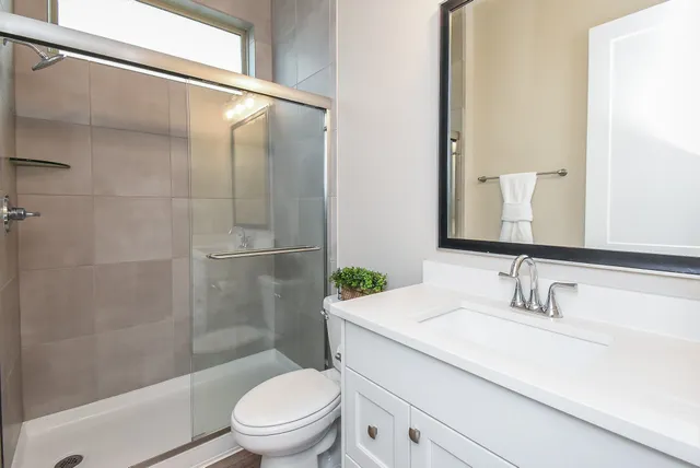 a bathroom with a sink toilet and shower