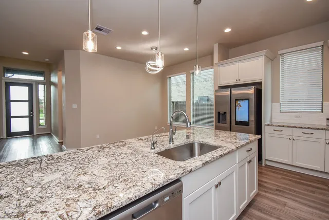 a kitchen with center island attached living room
